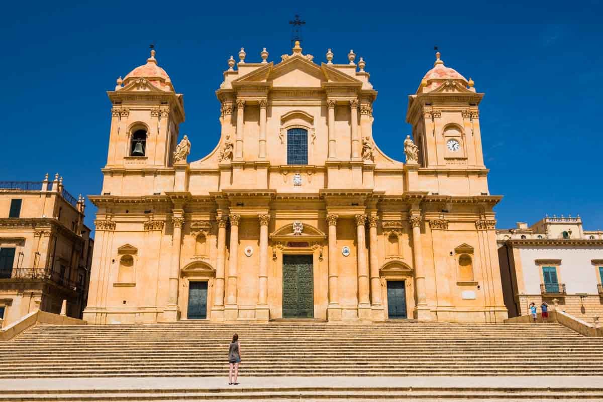 Noto, Sicily, a tourist visiting St Nicholas Cathedral (Noto Cathedral, Cattedrale di Noto), a Baroq