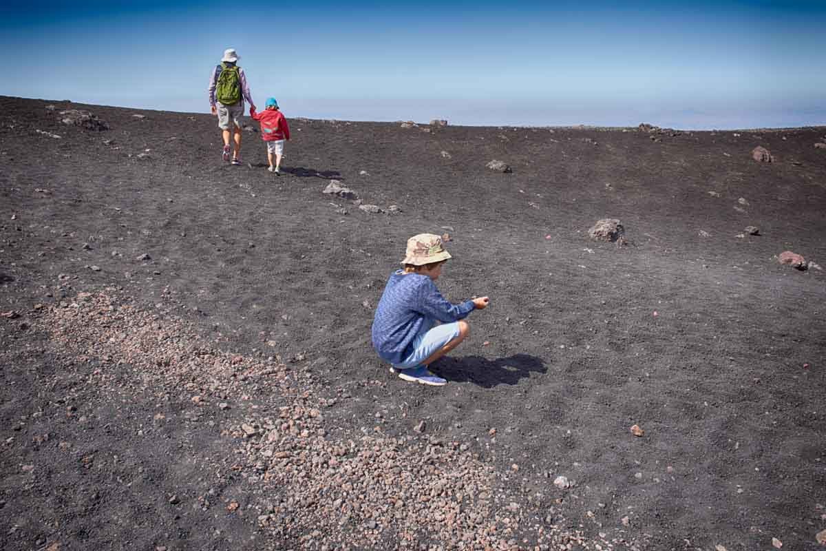 Senior woman and two grandsons on Mount Etna, Catania, Sicily, Italy